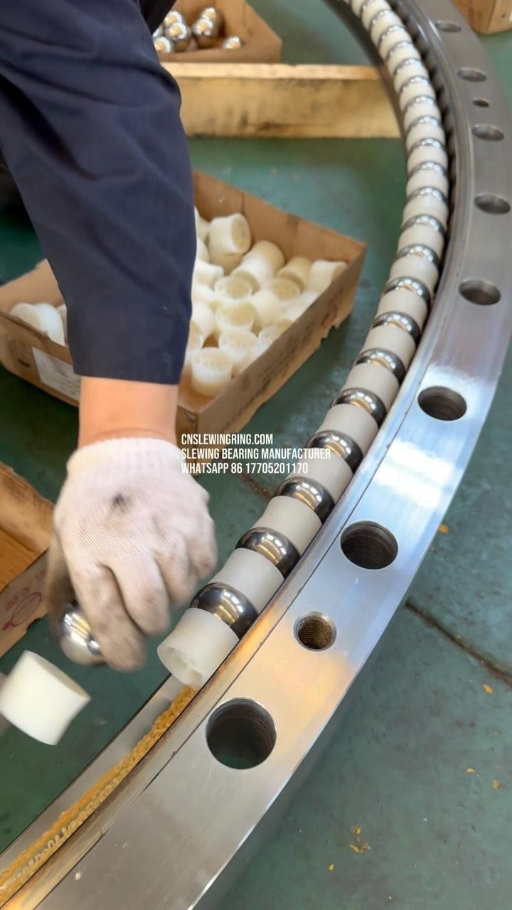 This is a large slewing bearing with two raceways and we are installing balls and spacers on the…