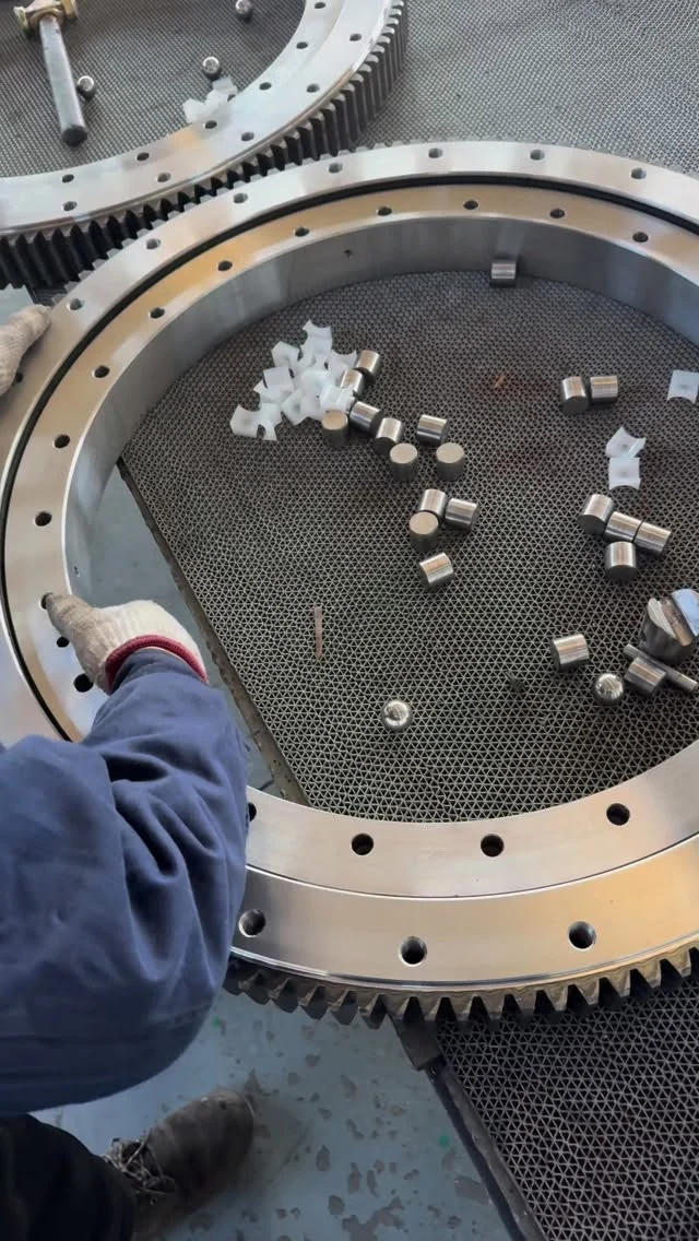 Assembly of an external gear cross-roller slewing bearing in progress. The cross-roller design provides high load capacity and…