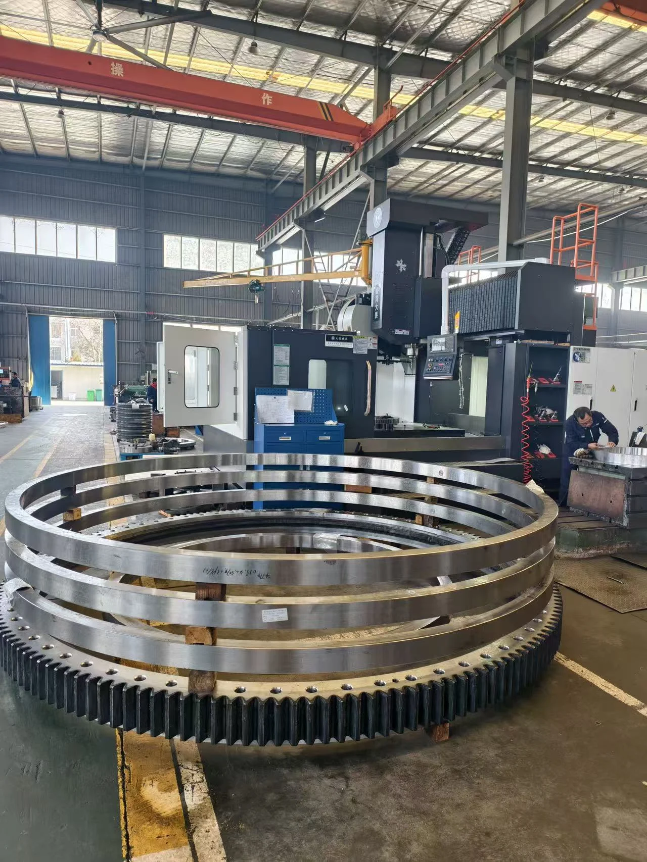 Principal rings and external gear component of a large three-row roller slewing bearing.