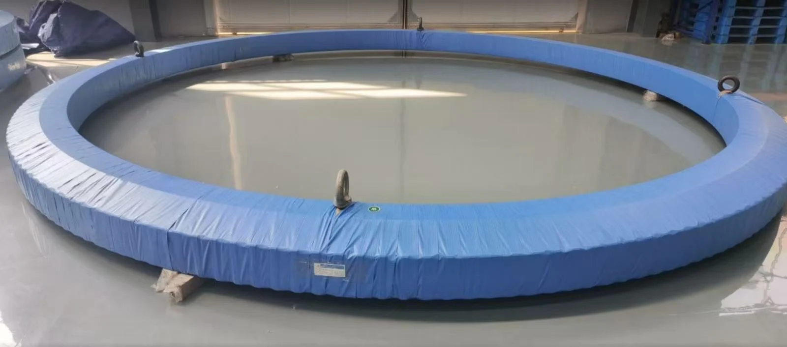 Giant slewing bearing protected for oversized export transportation.